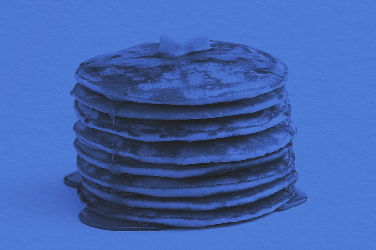 Pancakes stack with melting butter piece and pouring syrup