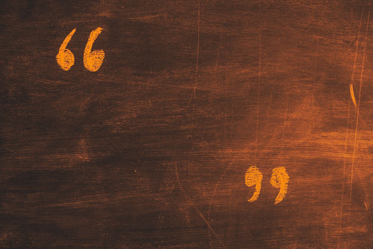 Quotation marks written on on blackboard