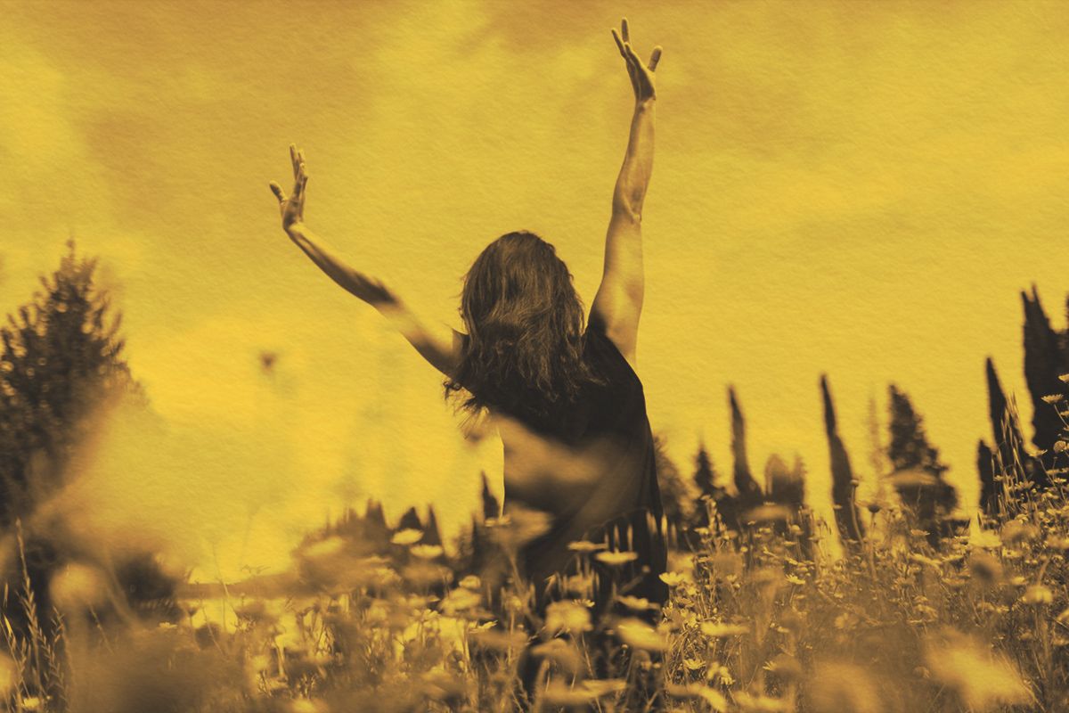 woman enjoying the sun in a flower field