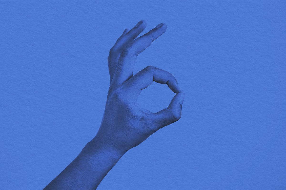 Woman making an "a-OK sign with her hand