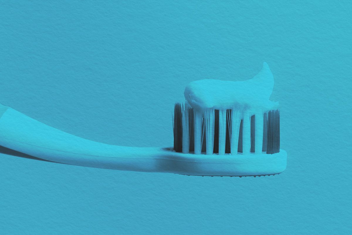 Toothbrush with white toothpaste close-up
