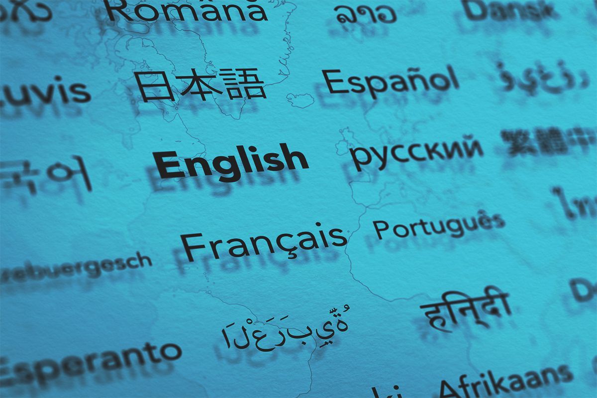Several languages on paper with world map background