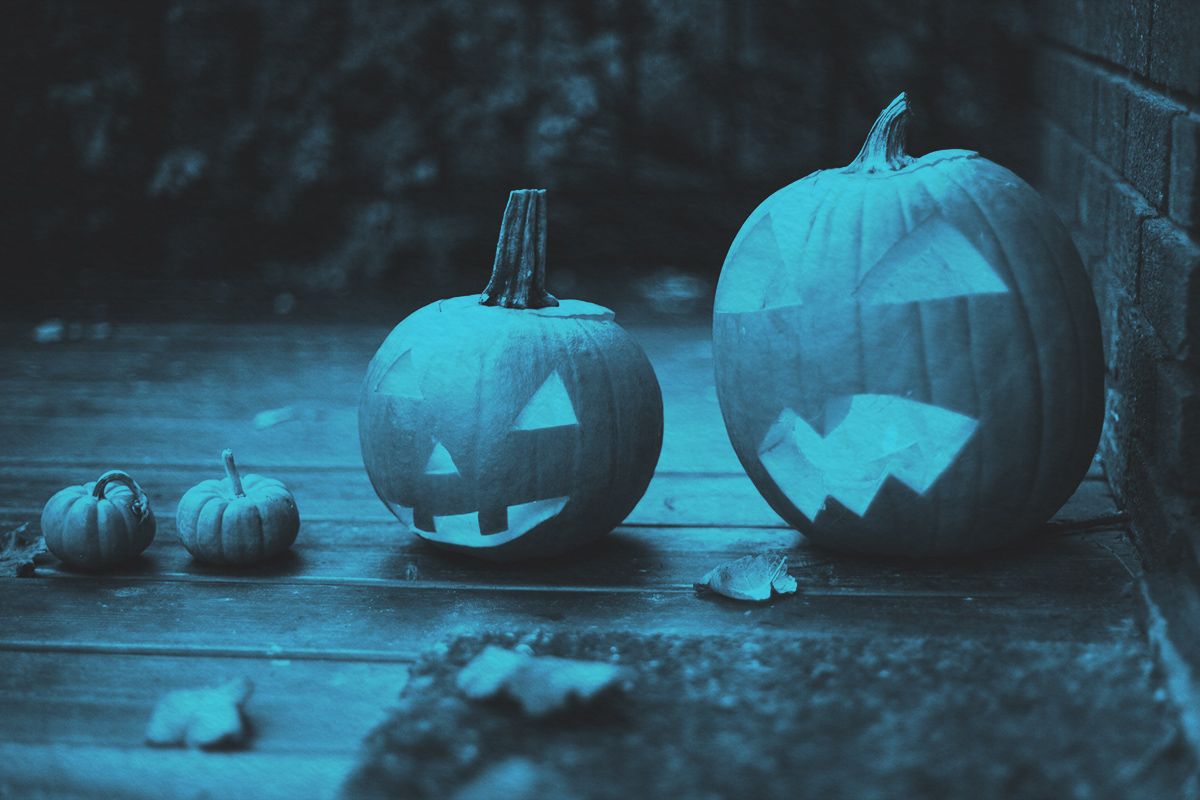 Jack-o’-Lantern carved pumpkins outside front door