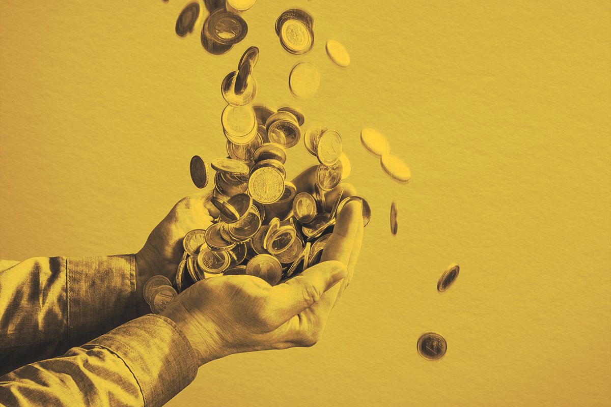 Money coins raining into human hands