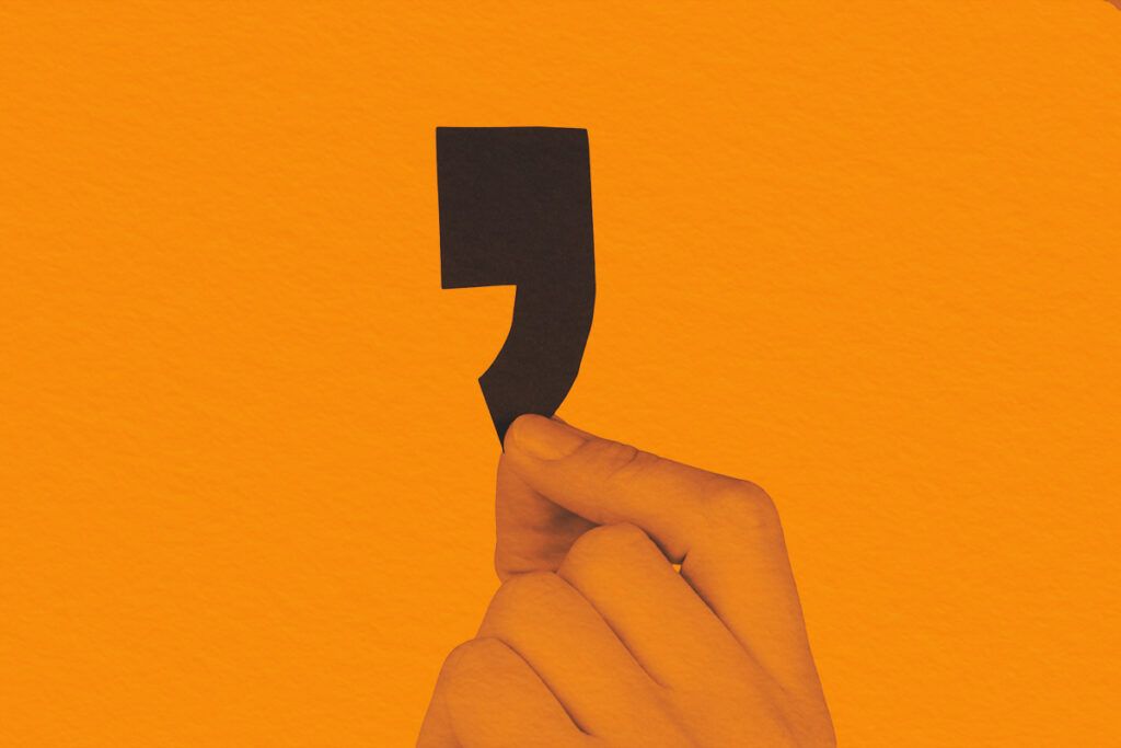 One Hand Holding Black Comma