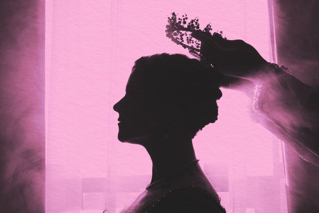 Silhouette of women getting crown put on her head