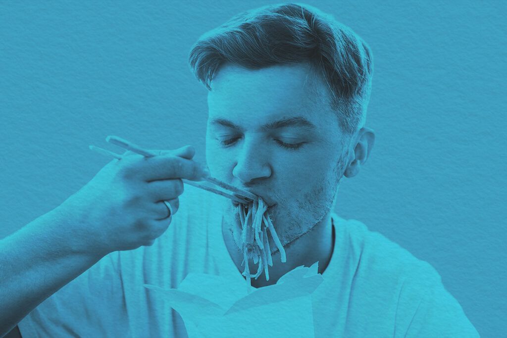 Close-up of a man eating noodles