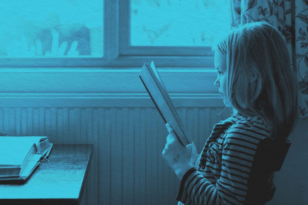 Young girl reading book in school