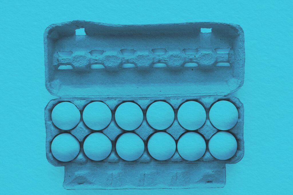 flat lay of white eggs in a carton tray
