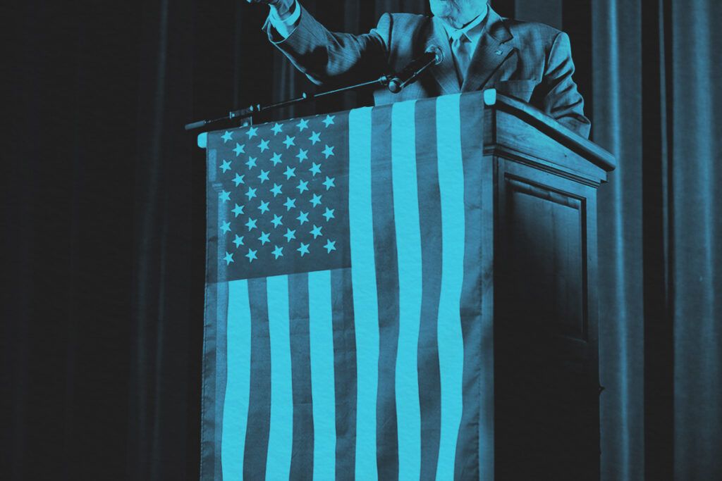U.S. Politician on stage with American flag over the podium