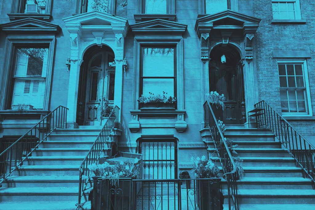 A row of townhouse entrances with stoop steps