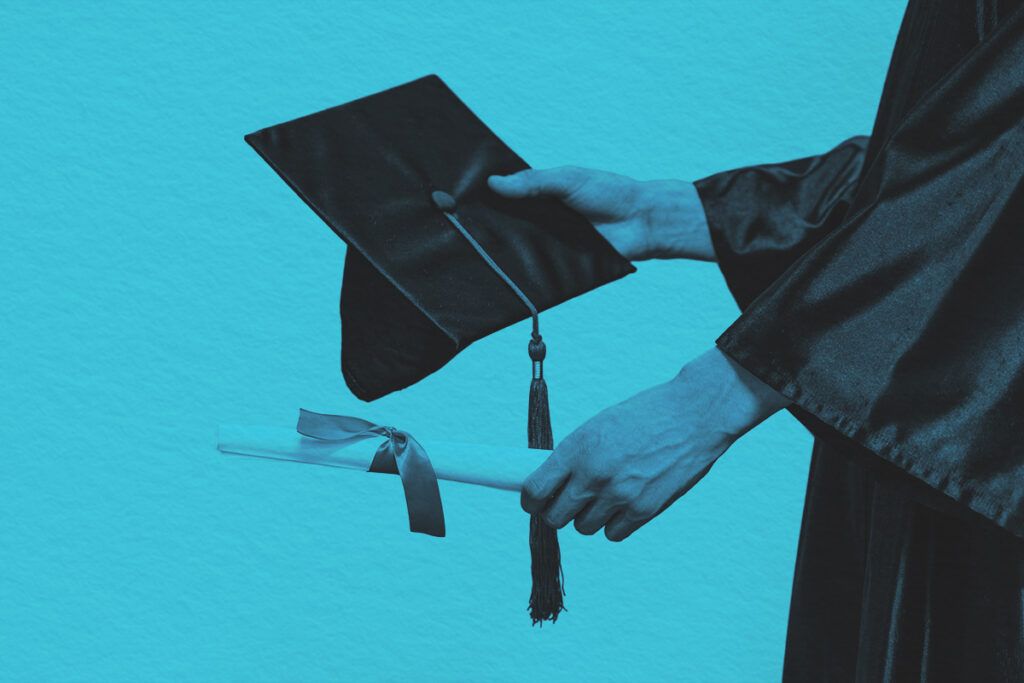 Close-up of graduate holding cap and diploma