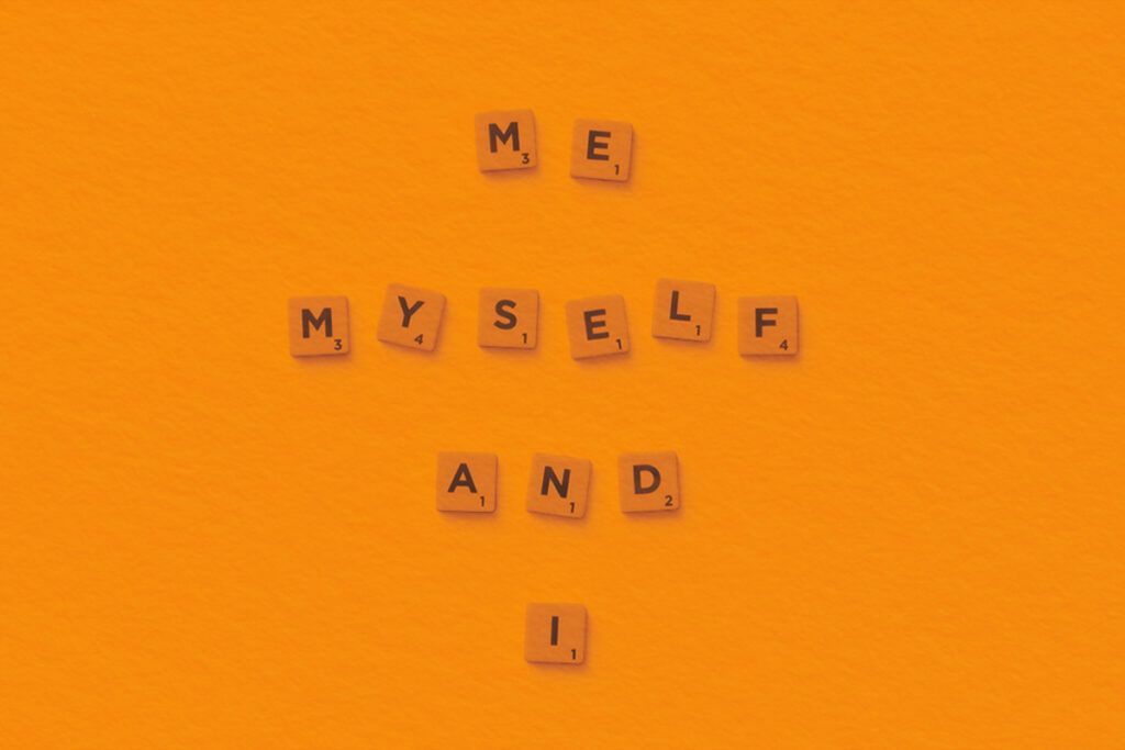 Minimalist composition of Scrabble tiles spelling 'Me, Myself, and I'