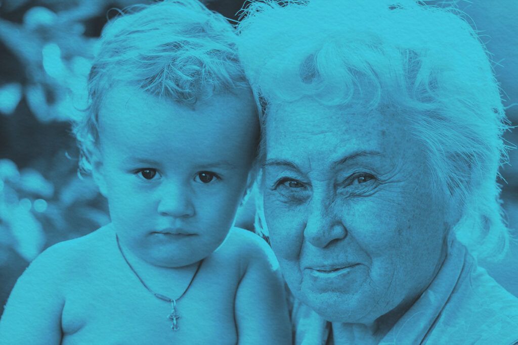Charming portrait of a grandmother with her grandchild in a sunny garden setting