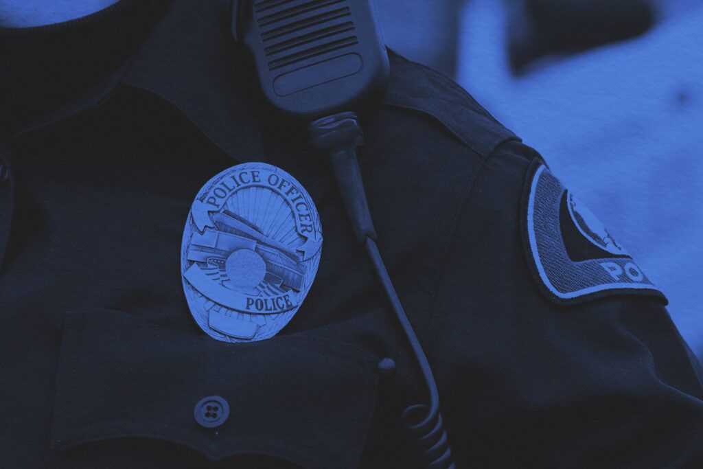 A police officer in uniform with a badge
