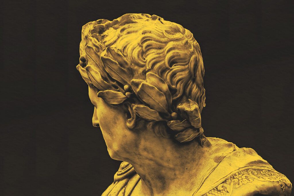 A roman statue wearing a crown of laurels